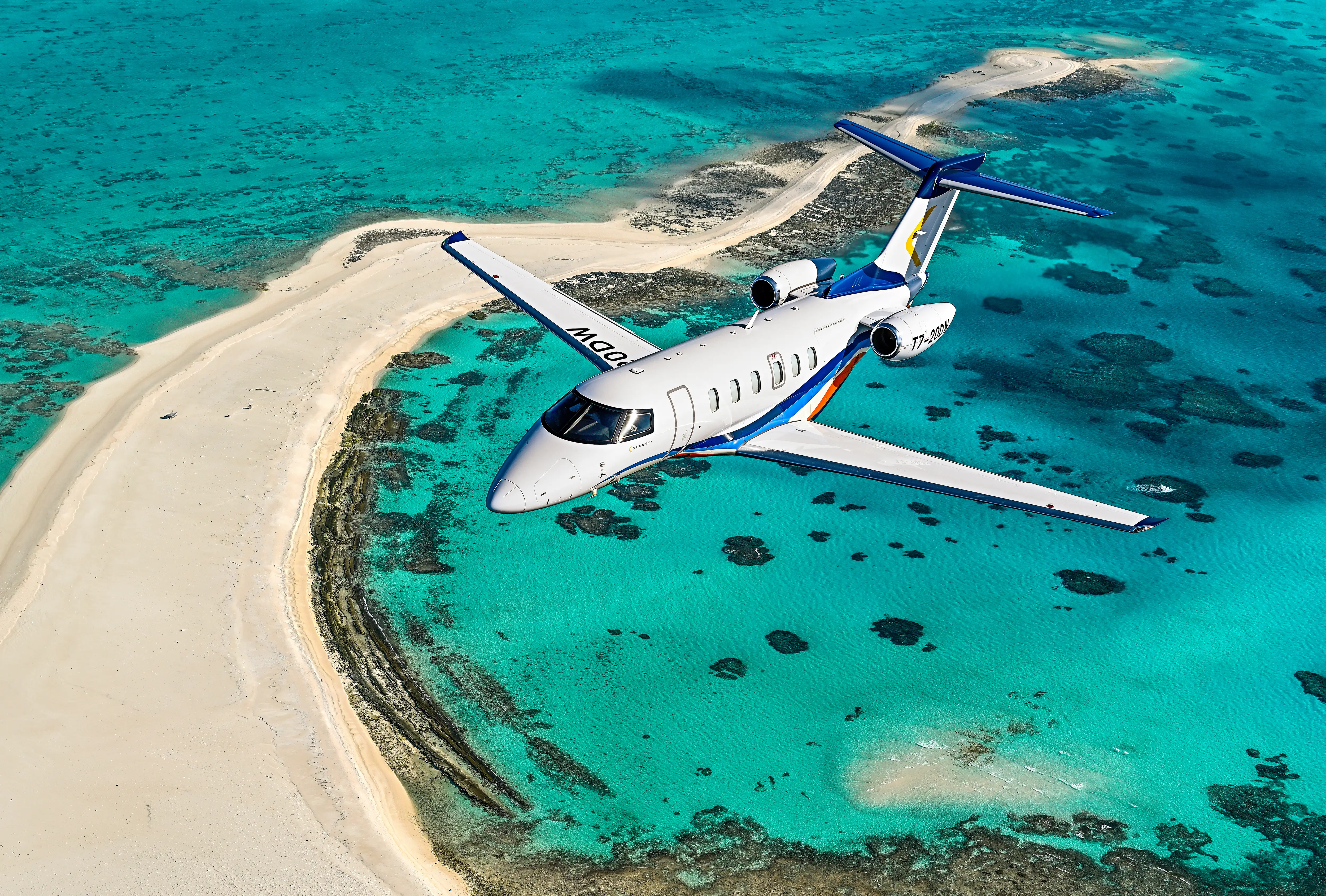 Private jet flying above clouds